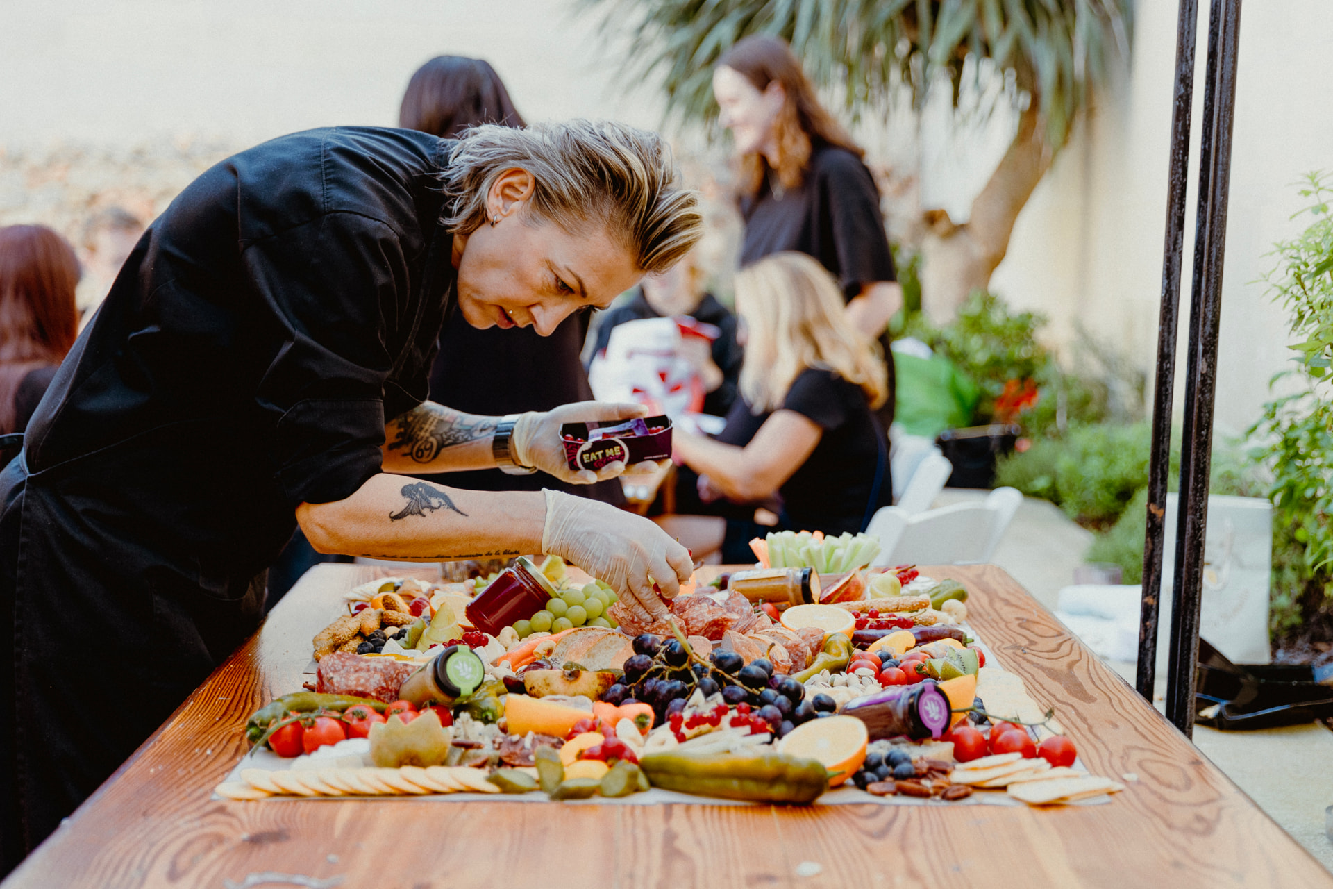 Long shared table being laid out with food
